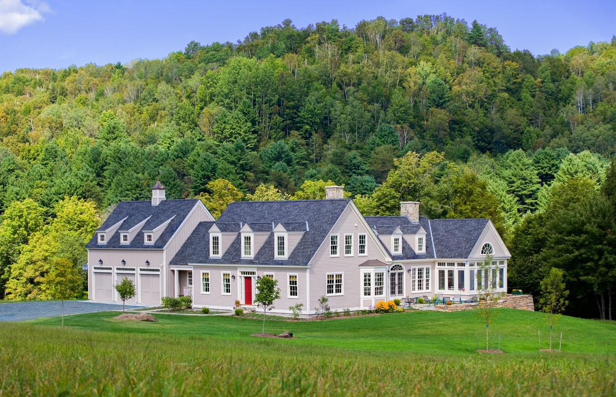 large gray house in the mountains in the summer