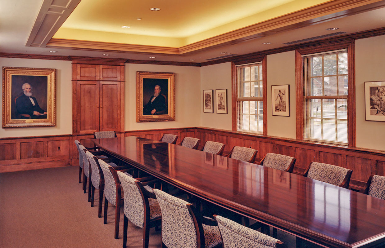 board room with a long wooden table and chairs