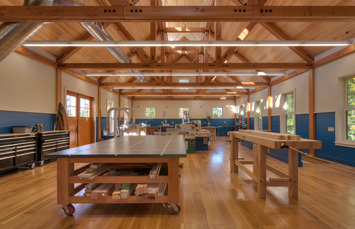 large wood shop with exposed ceiling framing
