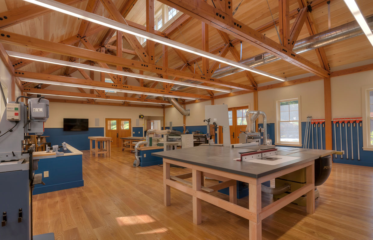 large wood shop with exposed ceiling framing