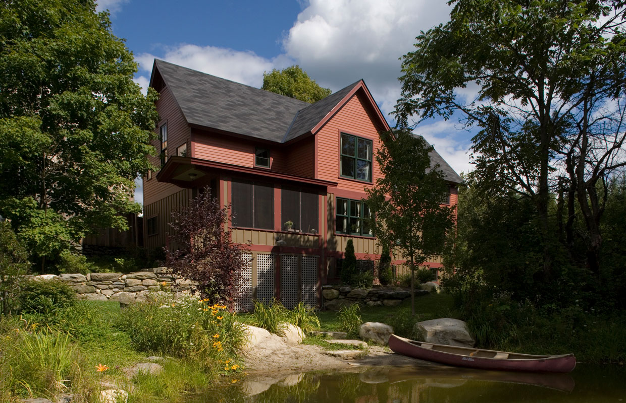 brown house near water with a canoe