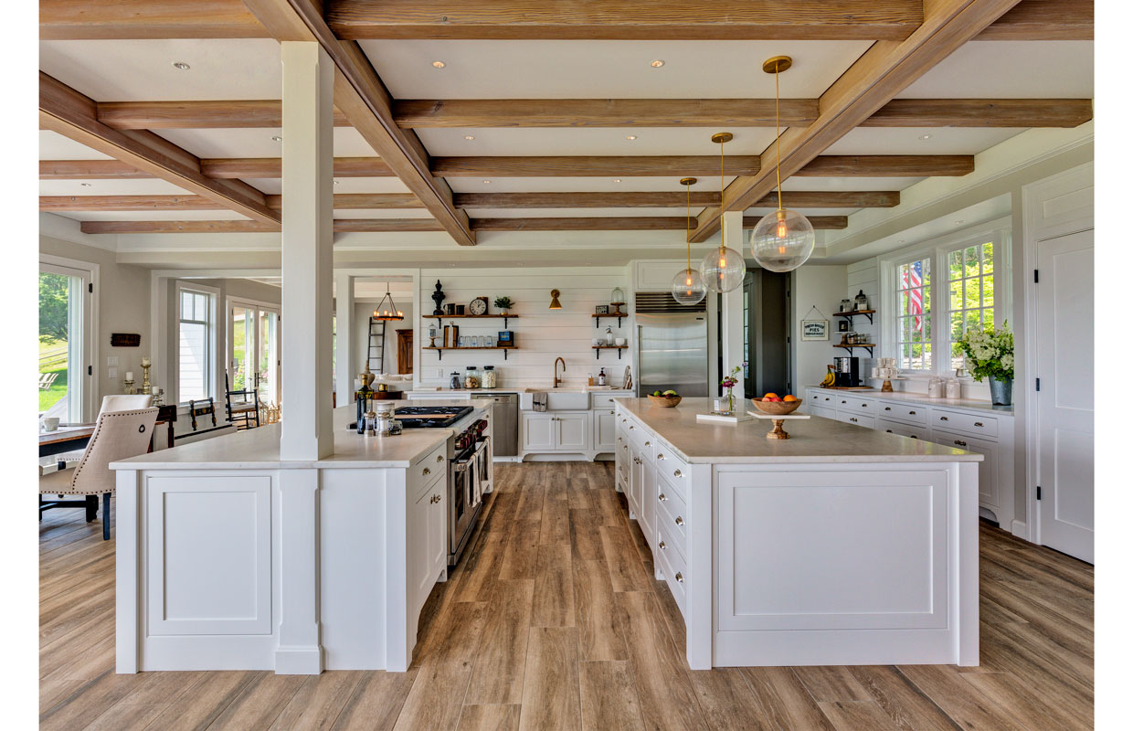 large white kitchen with exposed wood beams on the ceiling