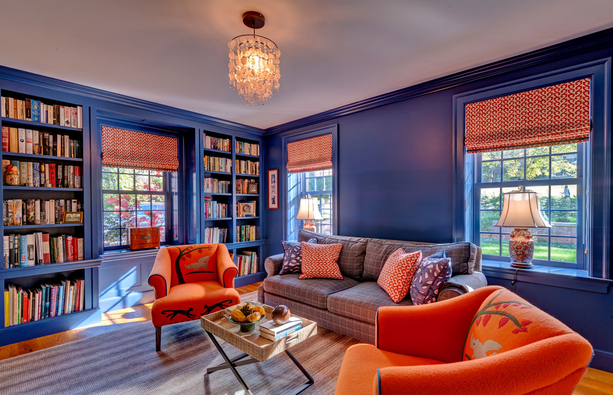 colorful reading room with orange furniture and bright blue walls