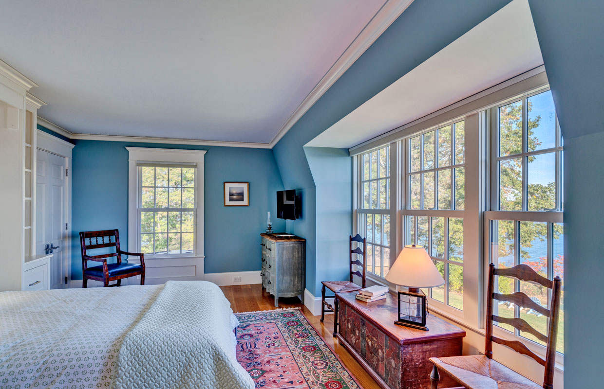bedroom with a large wall of windows and blue walls