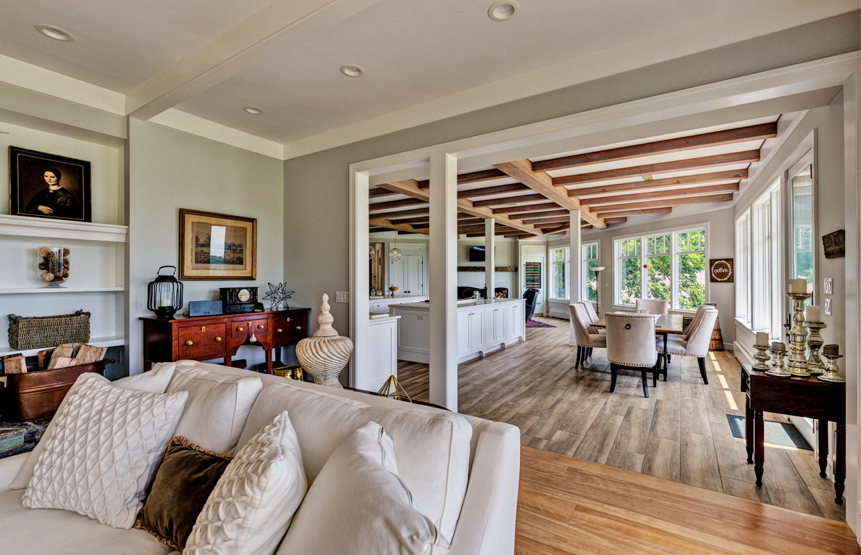 view into a dining room from the living room with exposed beams