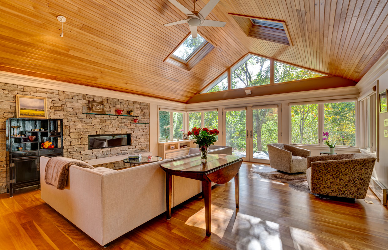 living room with tall a-frame ceiling and skylights