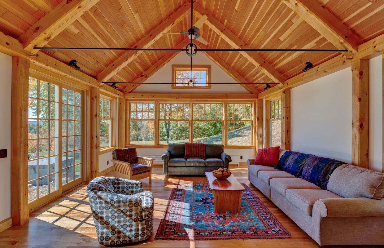 great room a-frame ceiling and lots of windows