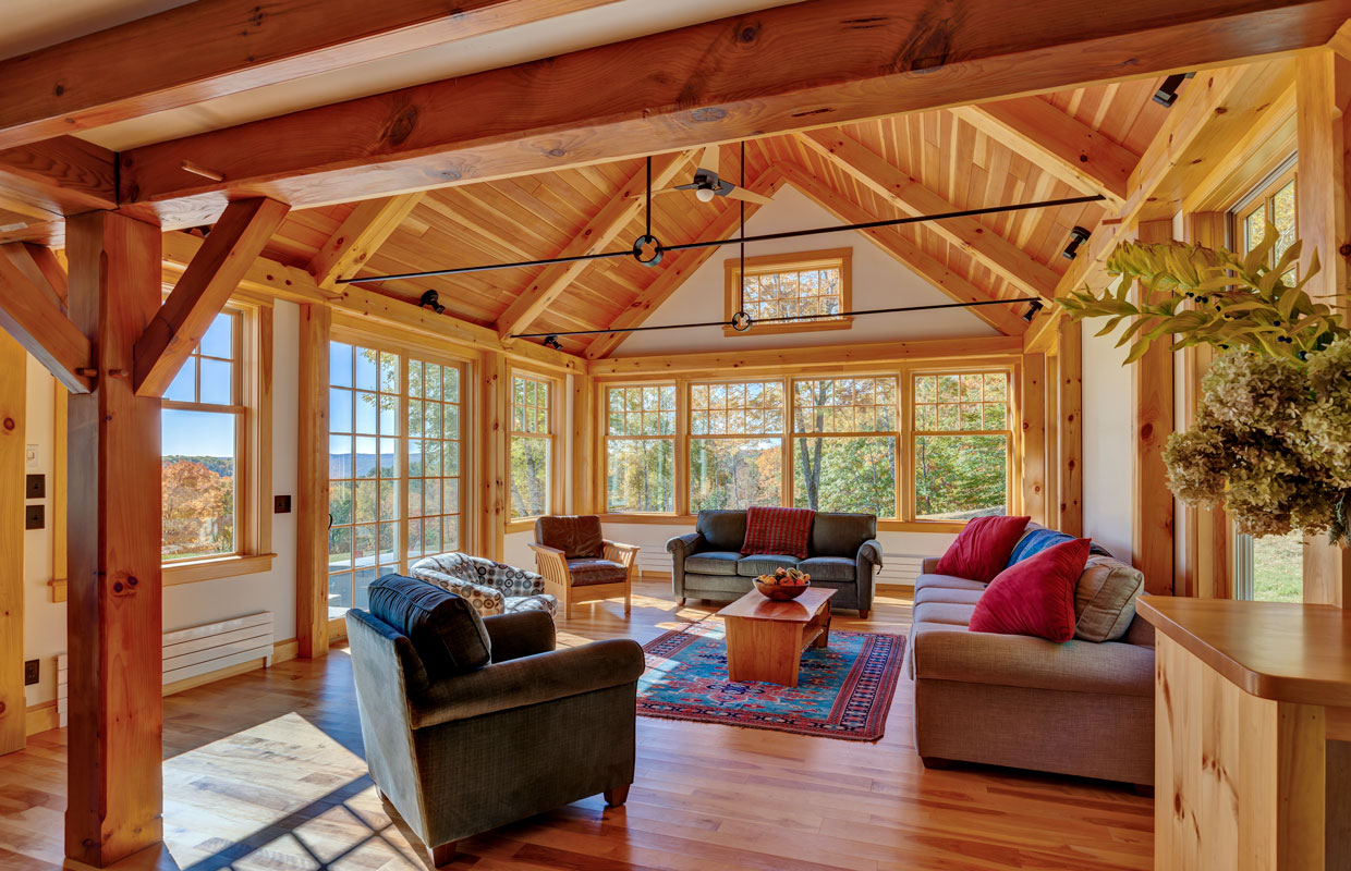 timber-framed sun room with couches