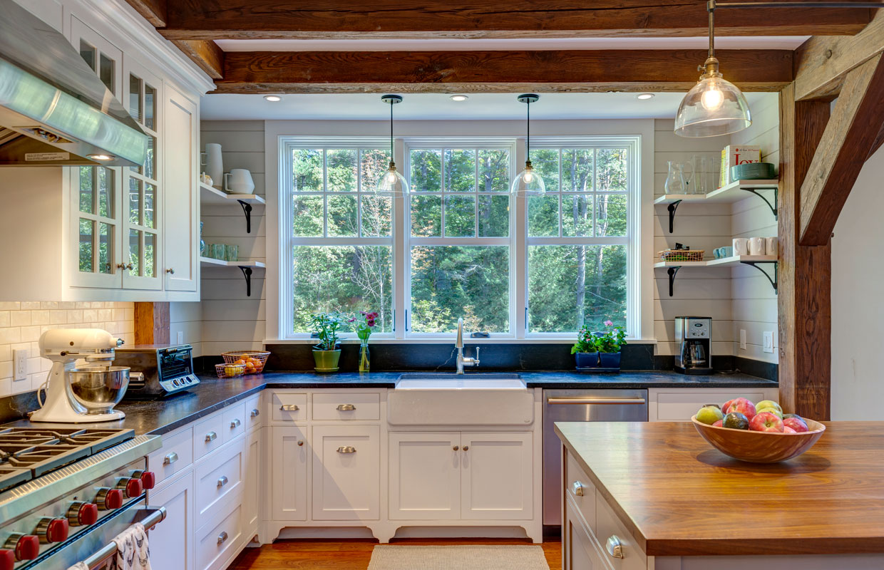 large kitchen with wood island and exposed beams