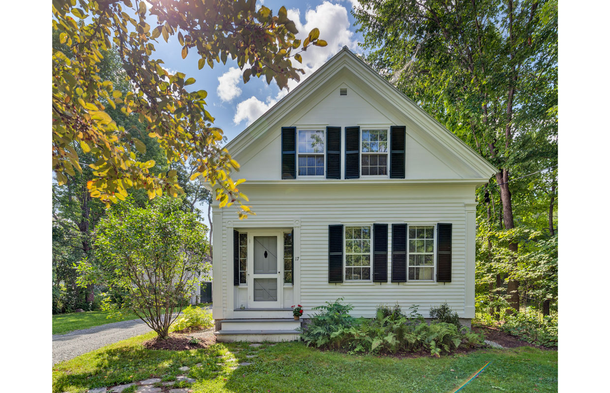 white house with black shutters view from the gable end