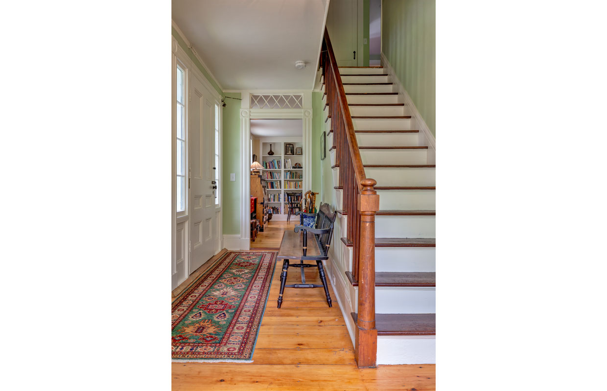 staircase with hallway to the left