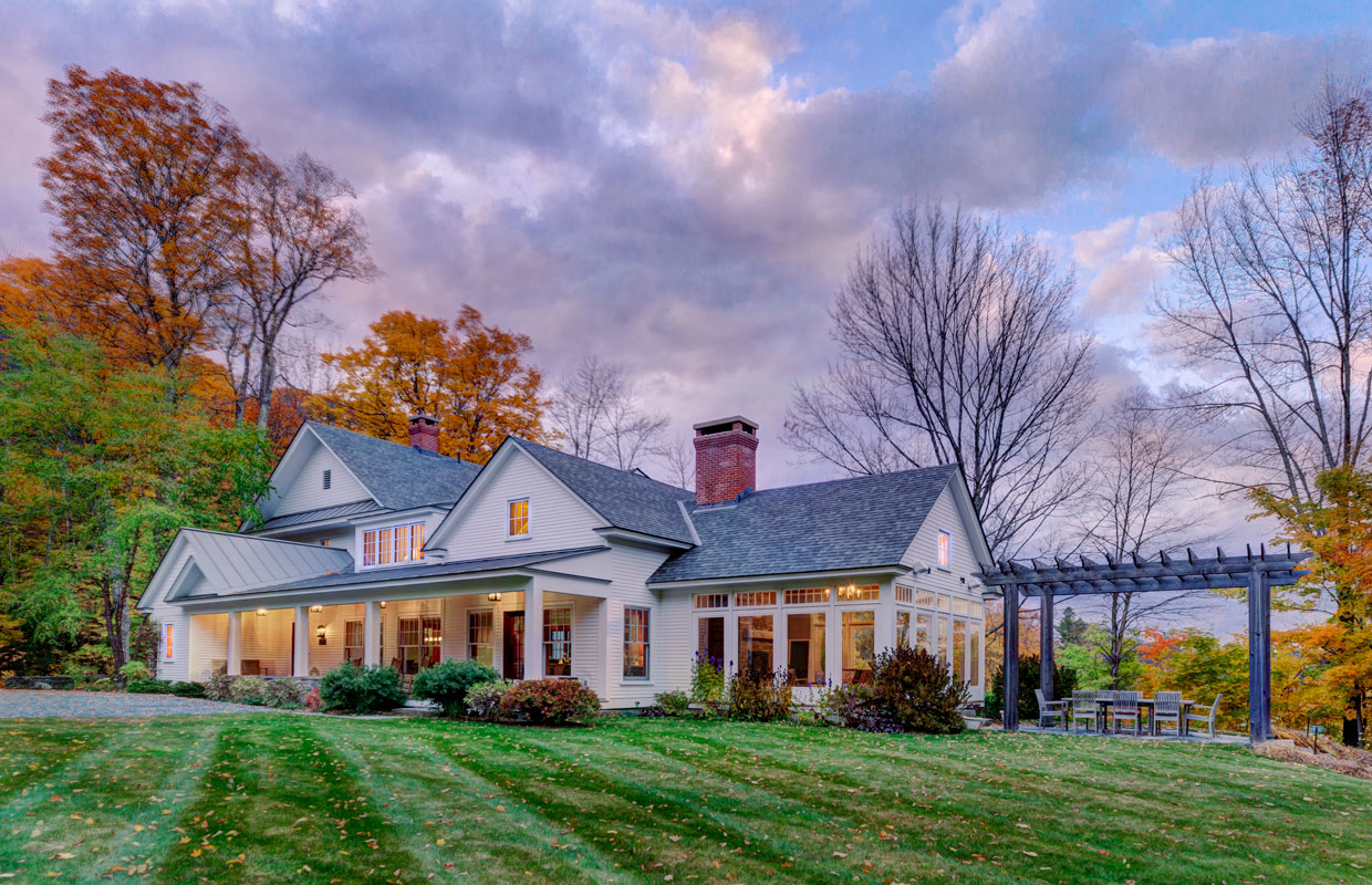 large white house with a pergola and green grass