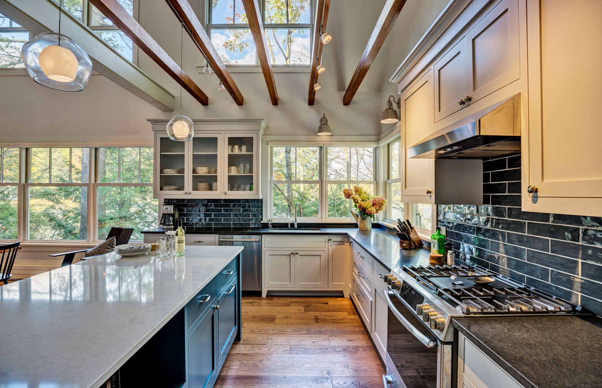 large kitchen with ceiling beams and a white island