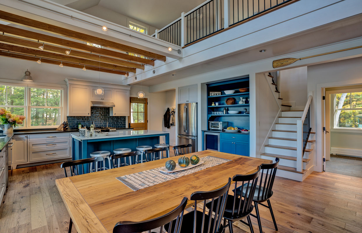 dining room with view into the kitchen and balcony above