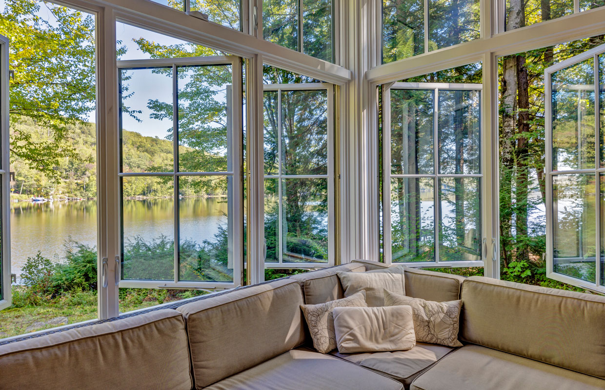 large windows open with a lake view outside