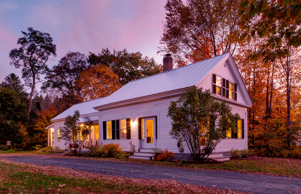 white house with black shutters at dusk