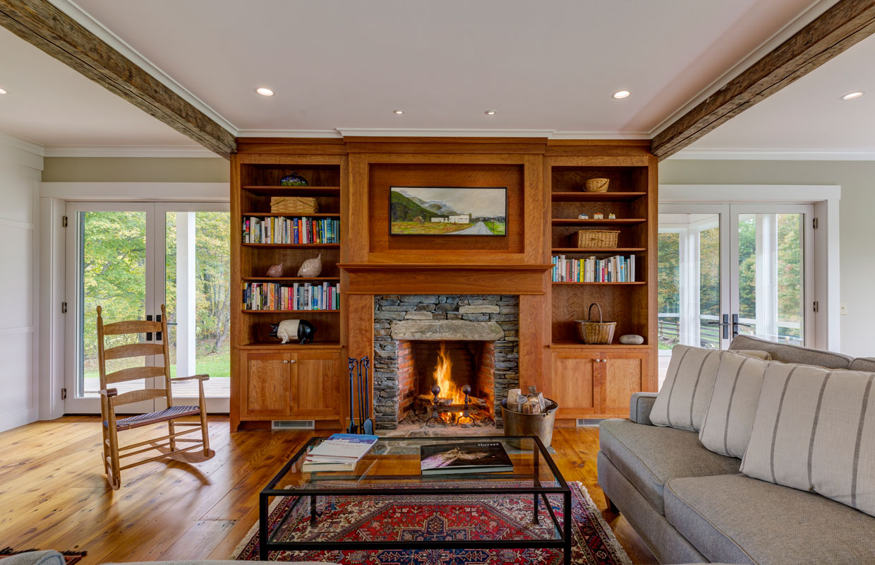 living room with a fireplace and surrounding bookcase