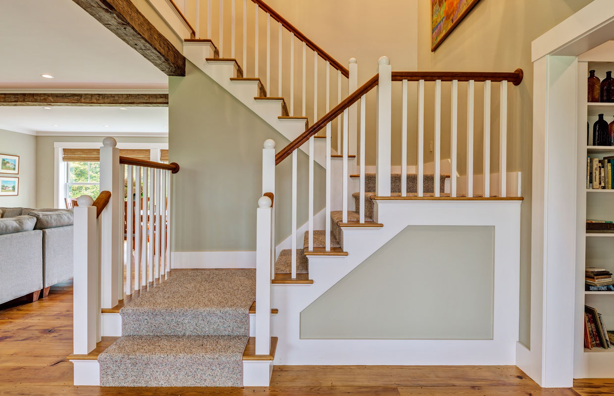 white staircase with light green paint on the walls