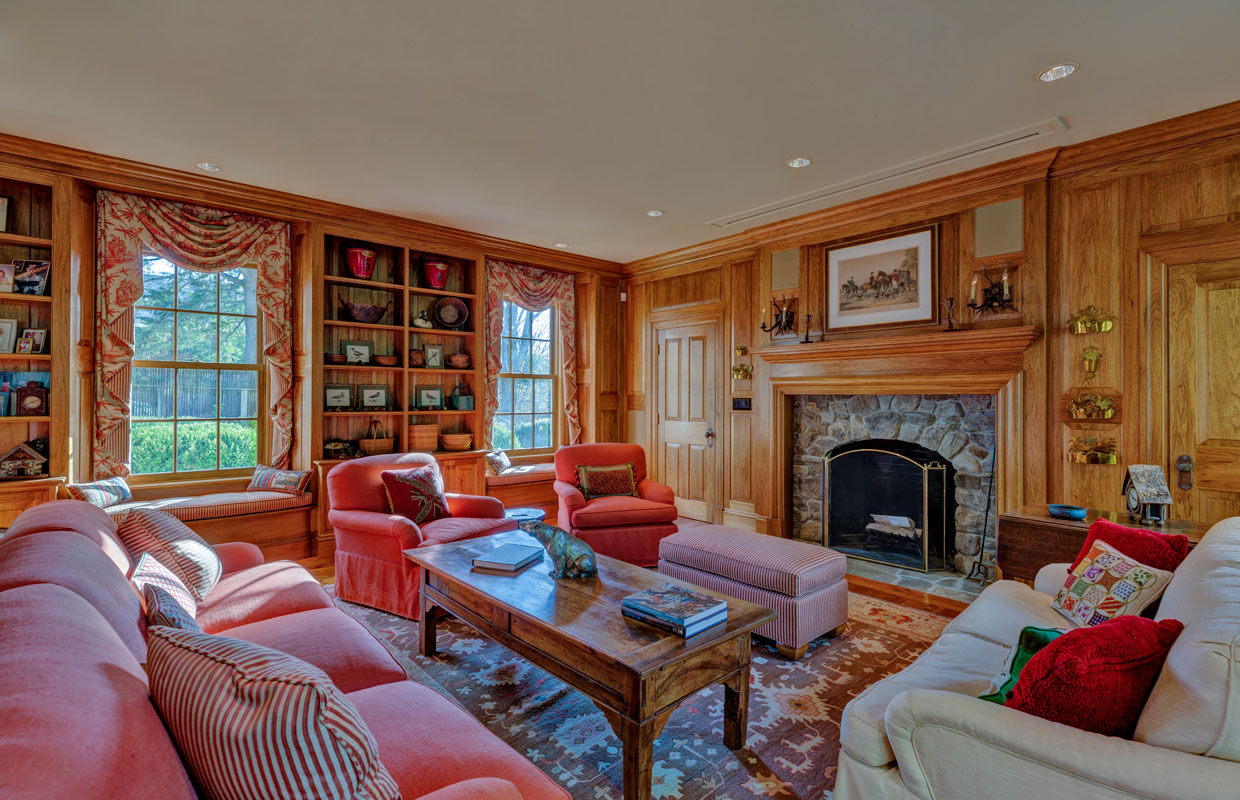 library in a home with a stone fireplace
