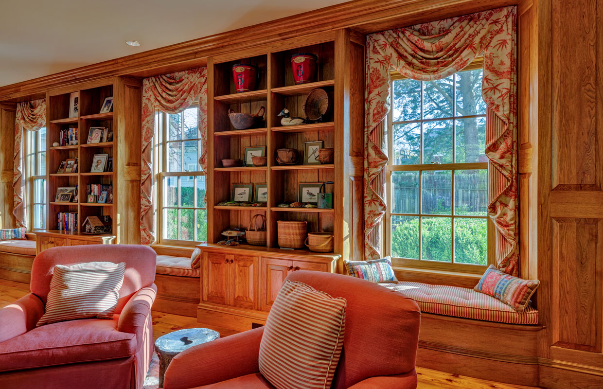 library in a home with fabric drapes over the windows