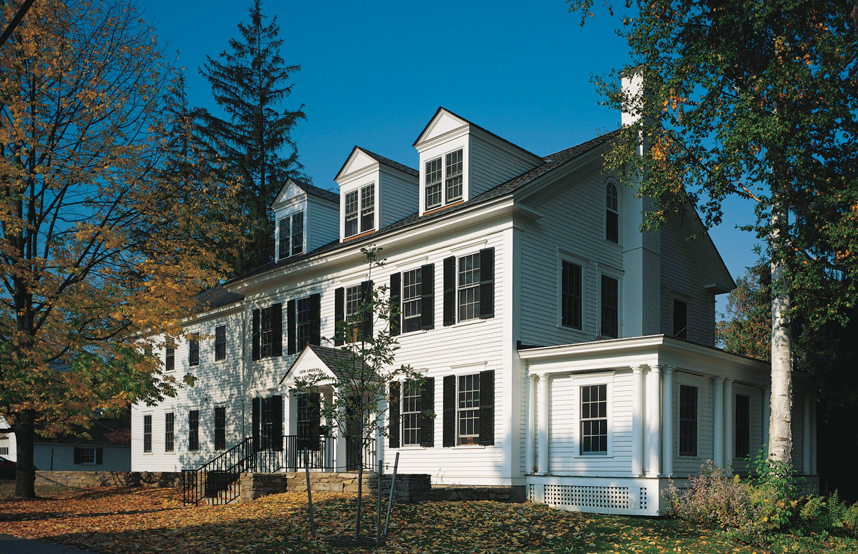 large white colonial house in the fall