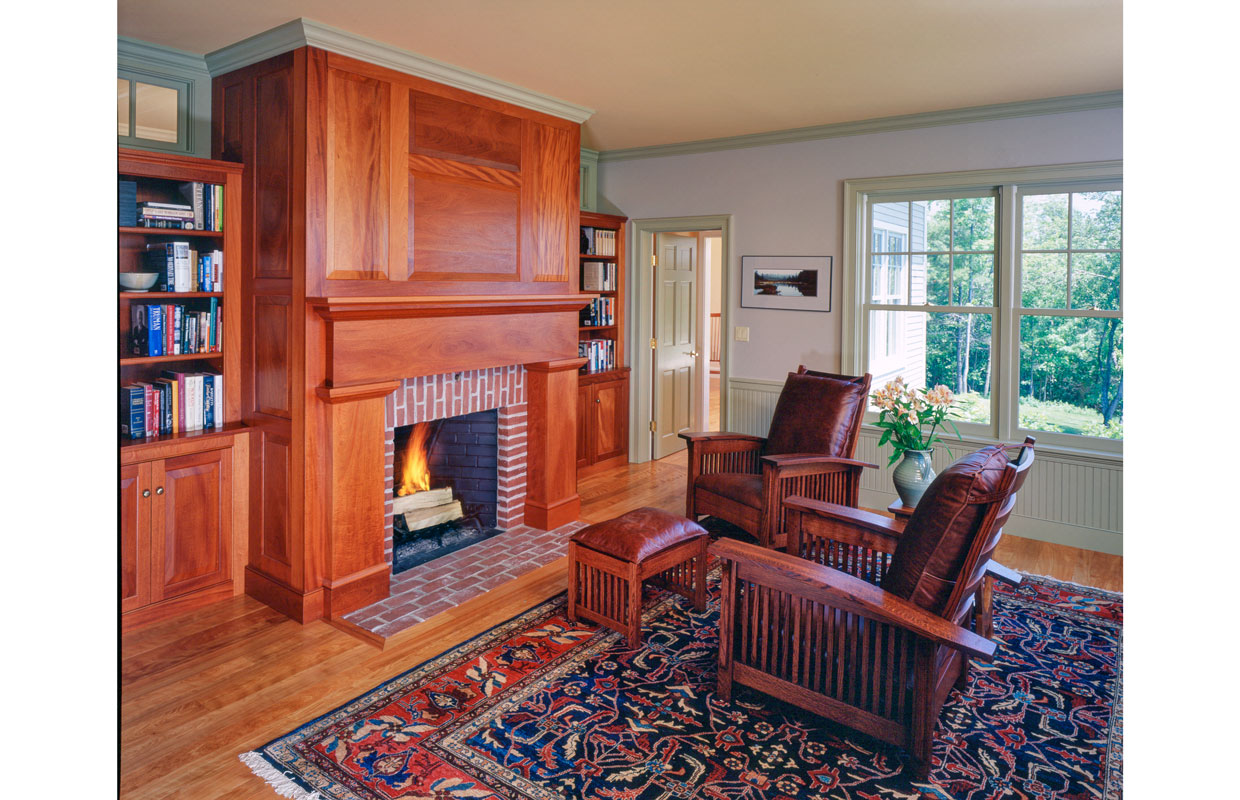 sitting room with a fireplace trimmed in wood