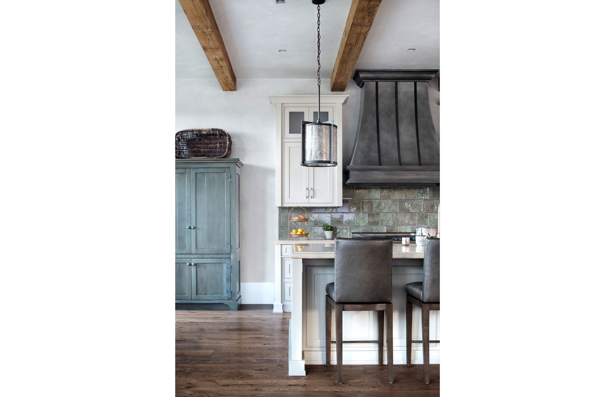 farmer's kitchen with rustic cabinets and high top chairs