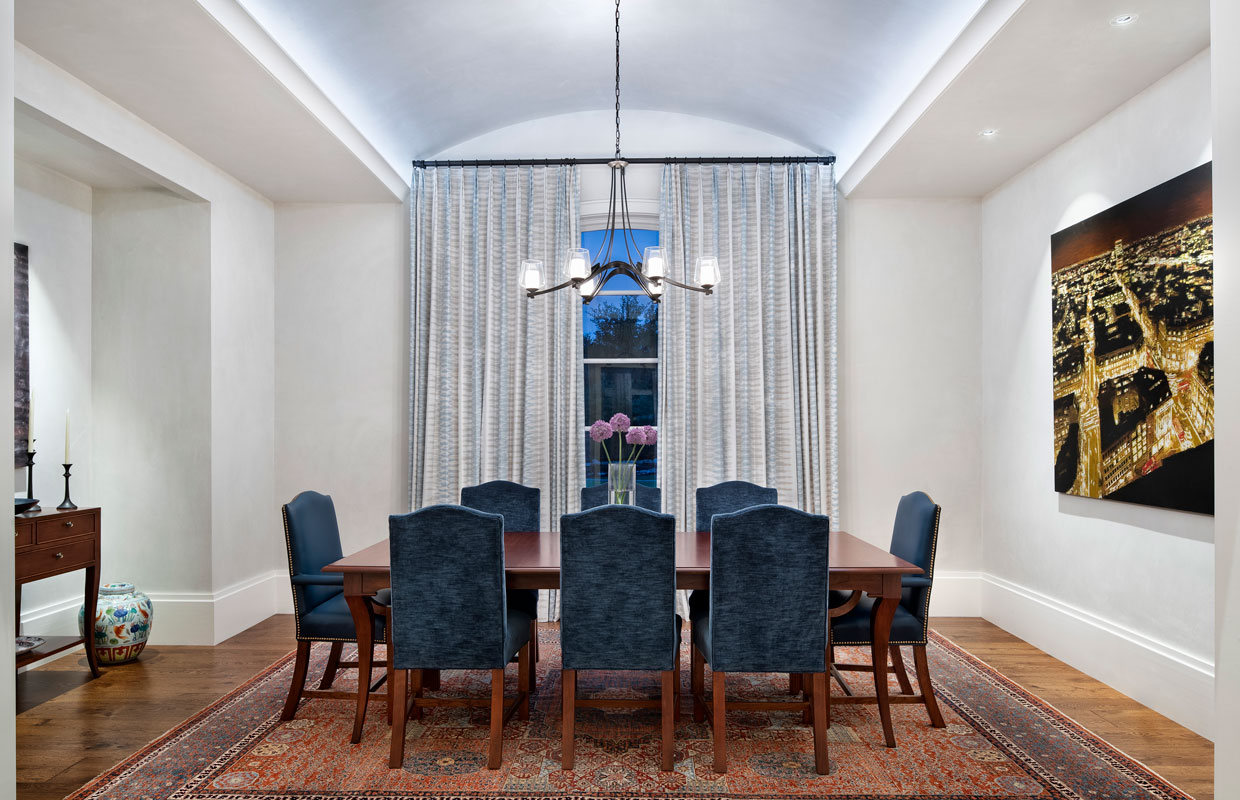 formal dining room with large windows and floor to ceiling drapes