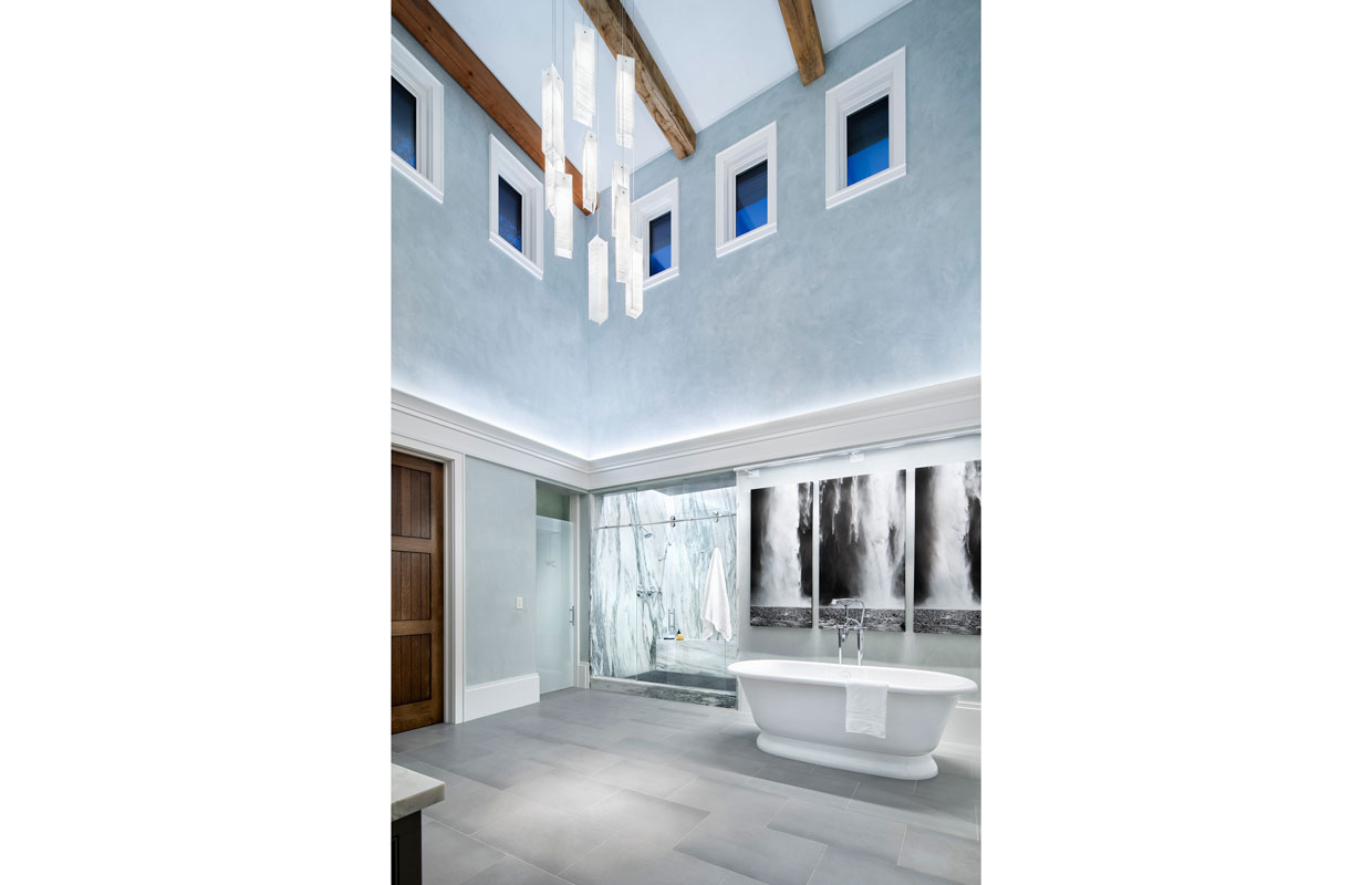cathedral ceiling bathroom with marble shower and large bathtub