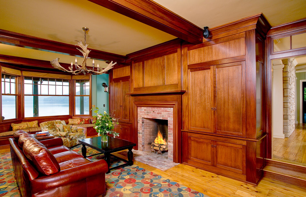 room with lots of wood accent and a fireplace and leather couch