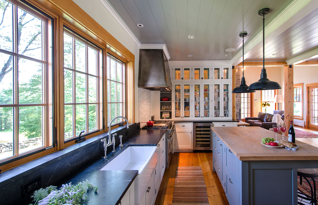large kitchen with stone countertops and a wood island