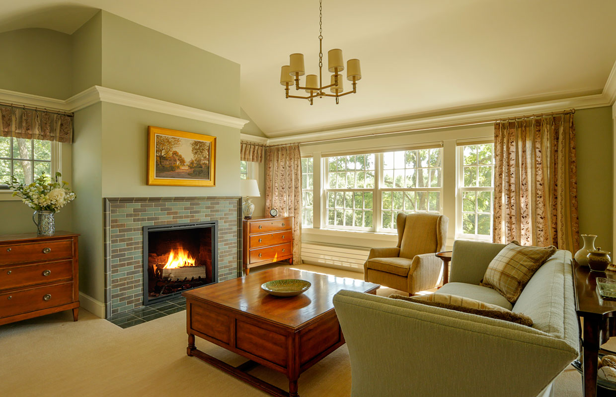 large sitting room with a fireplace and wooden coffee table