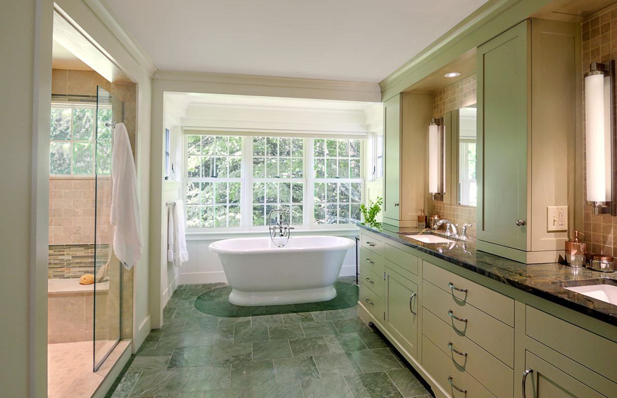 large bathroom with a tub at the back with lots of windows