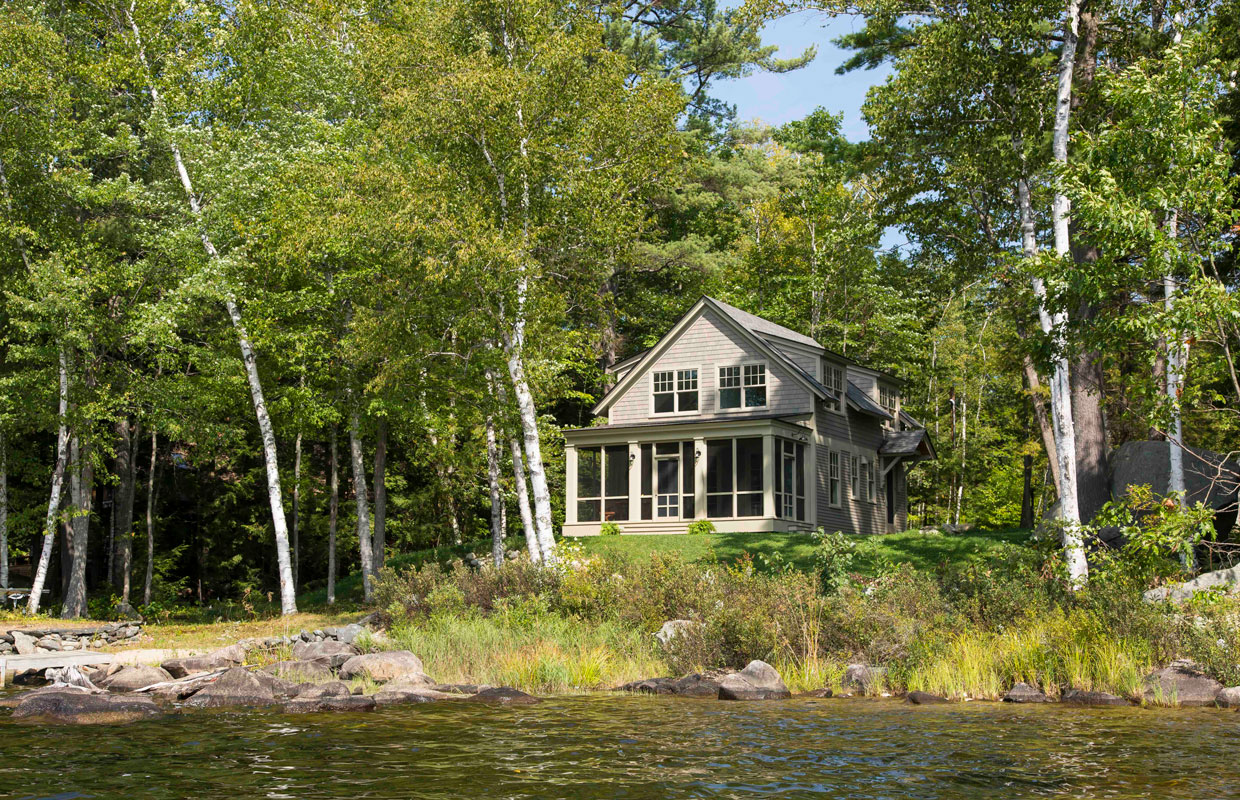 tan house in the woods