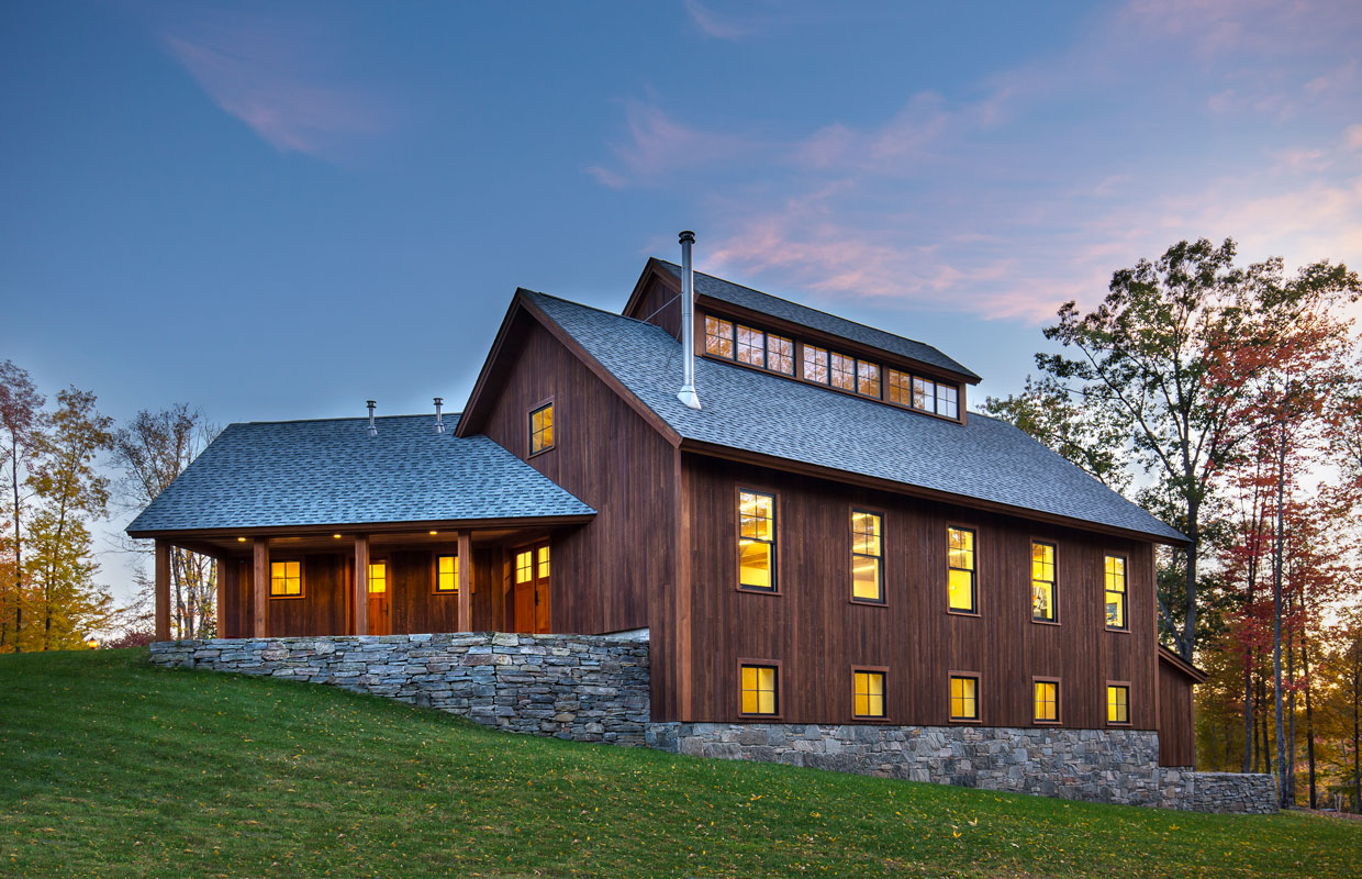 barn at dusk with solar panels and green grass