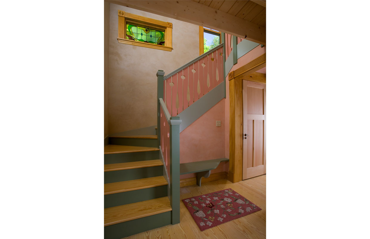 wooden staircase with maroon colored accents