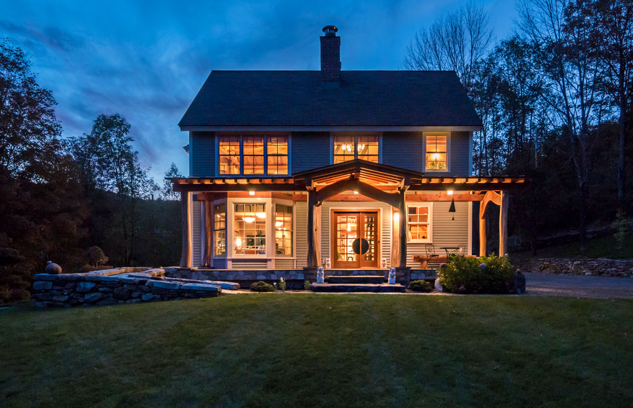 home from the outside at night with lots of lights on inside