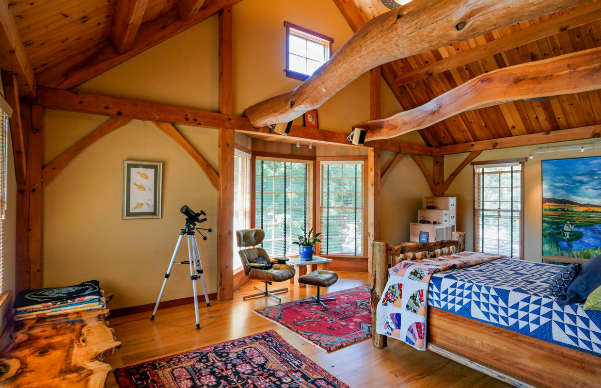 bedroom with lots of natural wood and tree trunk beams